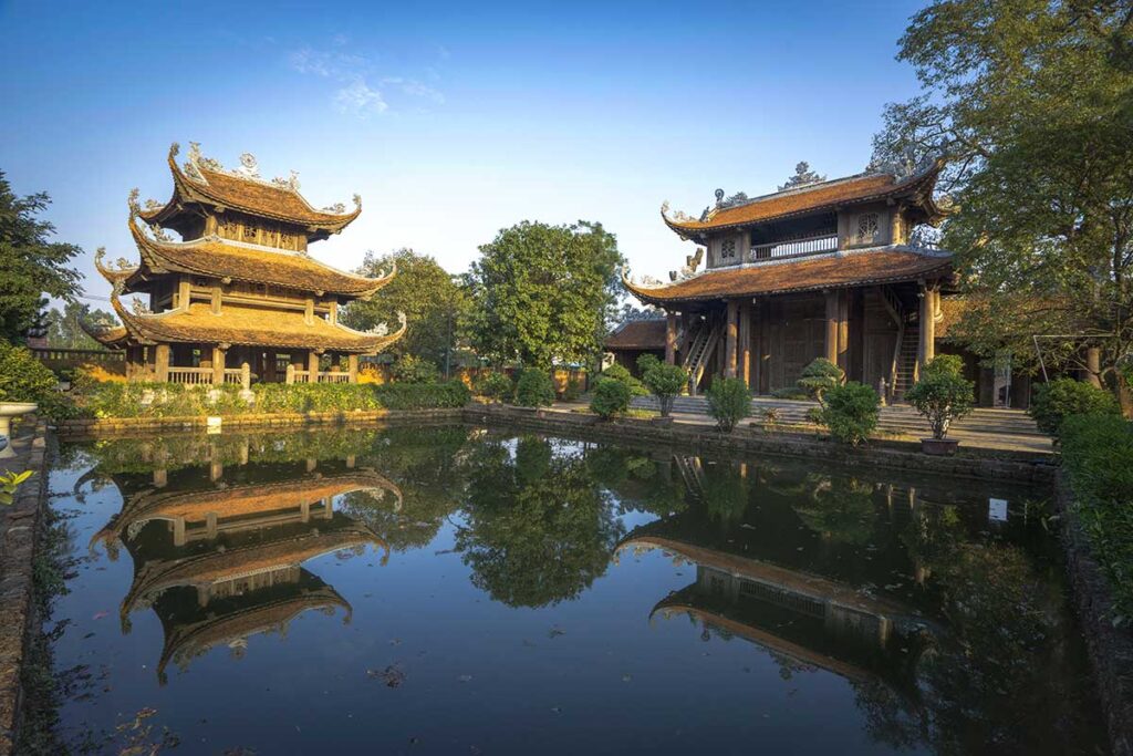 A small pond and two temple buildings of Nom Pagoda in Hung Yen