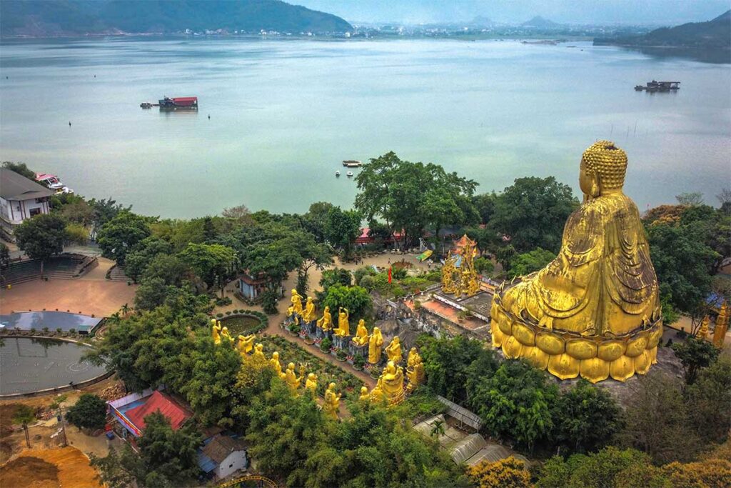 Buddha statues part of a theme park at Nui Coc Lake