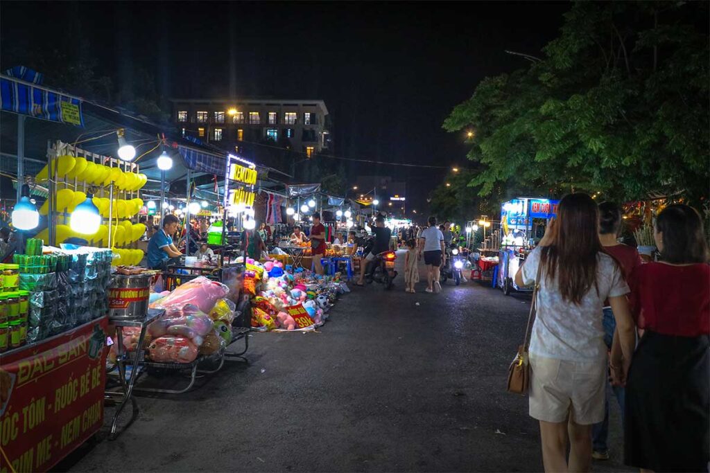 Locals walking over the Sam Son Night Market in the evening