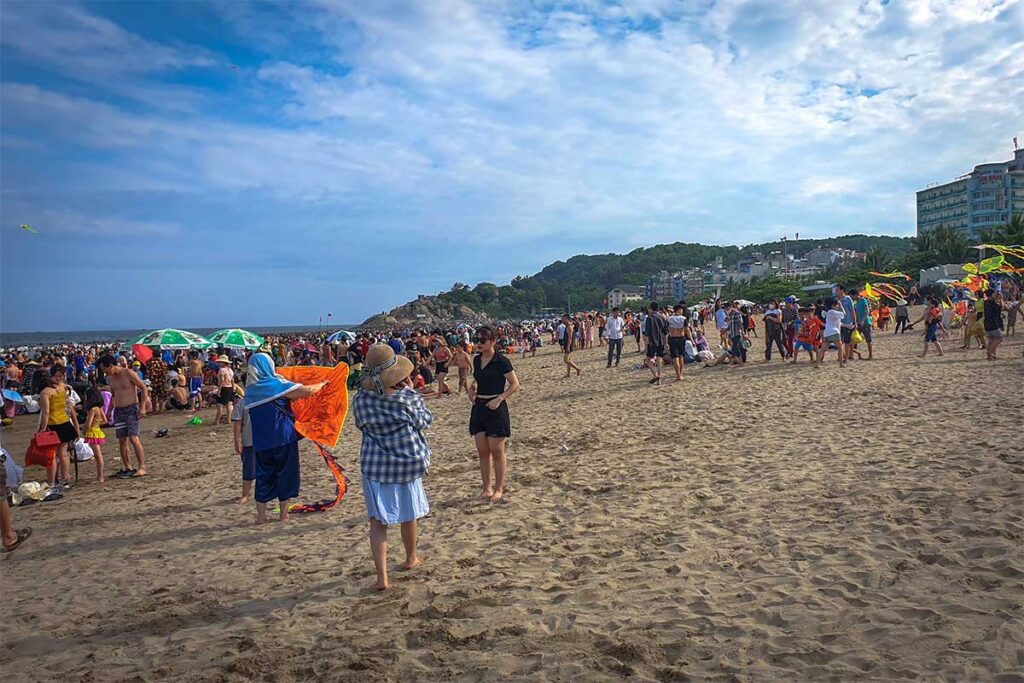 Lots of local people walking on Sam Son Beach