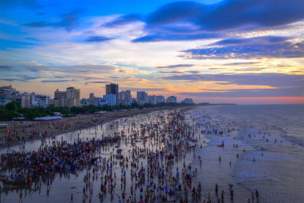 Extremely crowded Sam Son Beach during a public holiday seen in late afternoon during sunset