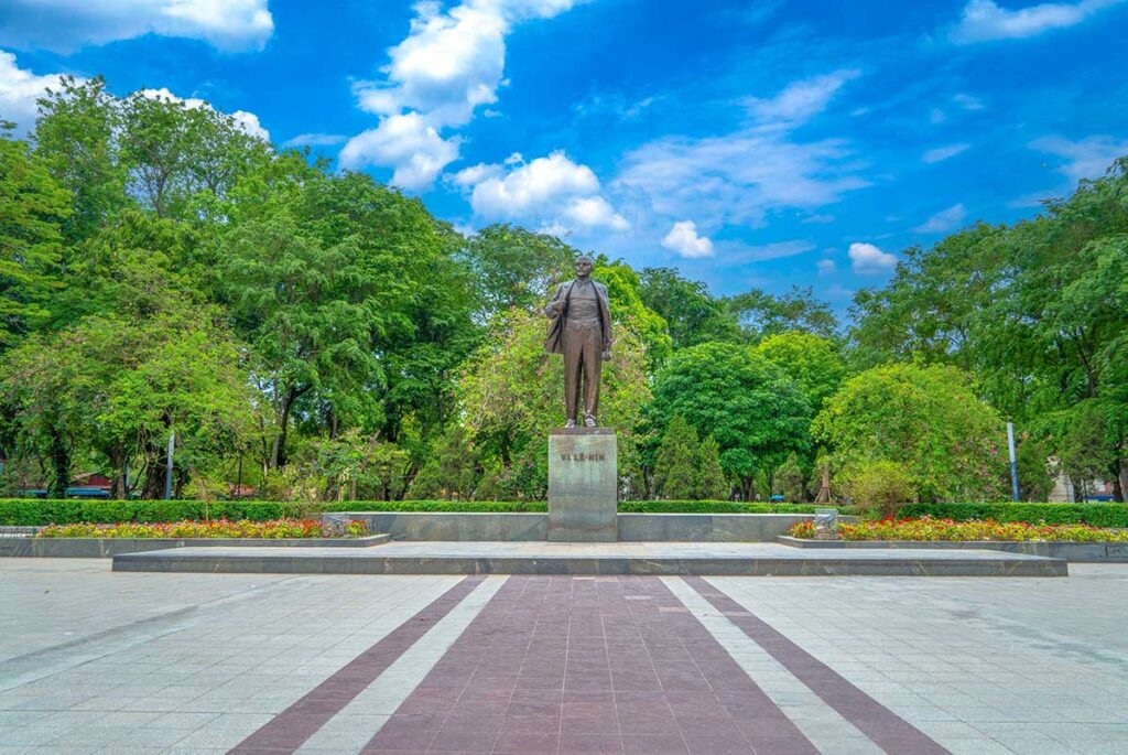 Lenin Statue at Lenin Park in Hanoi surounded by trees