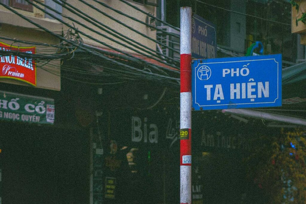 A blue street sign saying "Pho Ta Hien"  located in the Old Quarter of Hanoi