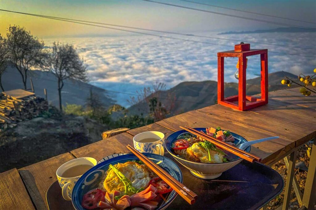 Noodle soup on a table outside Paang Village with direct views of the famous sea of clouds of Ta Xua