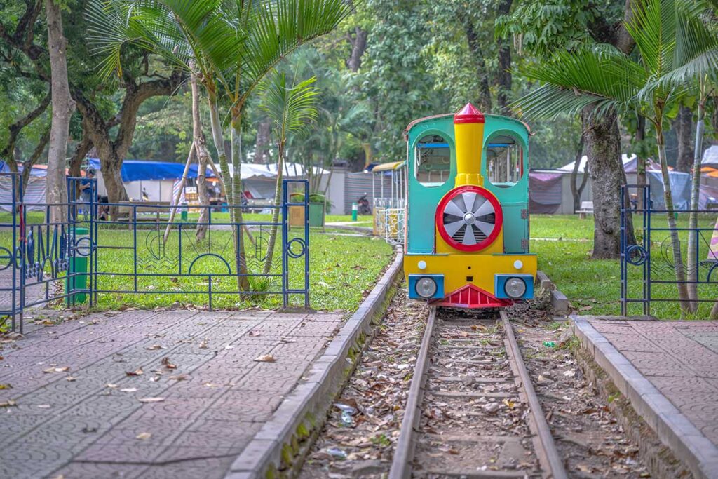 A kids train riding on a small track through Thong Nhat Park in Hanoi