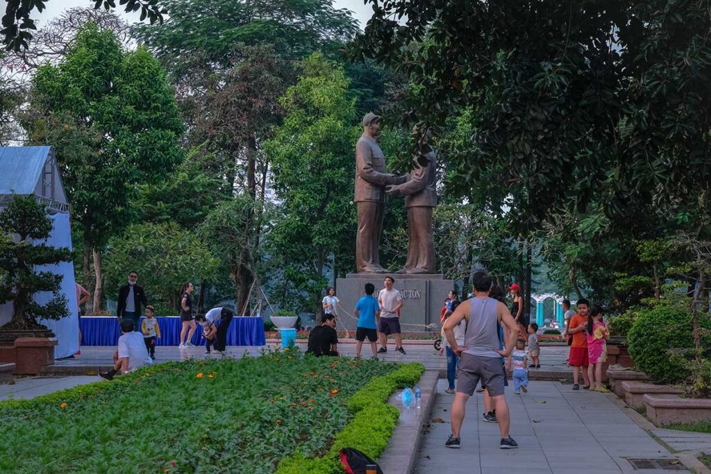 Locals are working out near a statue of Ho Chi Minh in Thong Nhat Park in Hanoi