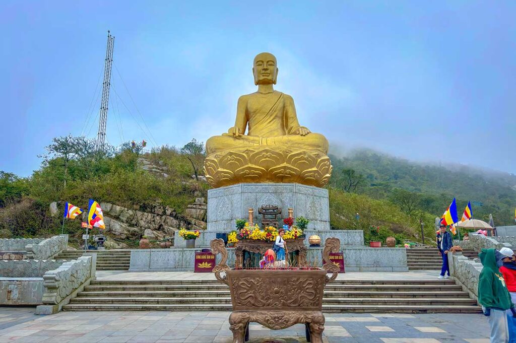 Large statue of Tran Nhan Tong on top of a mountain at Yen Tu Pagoda complex