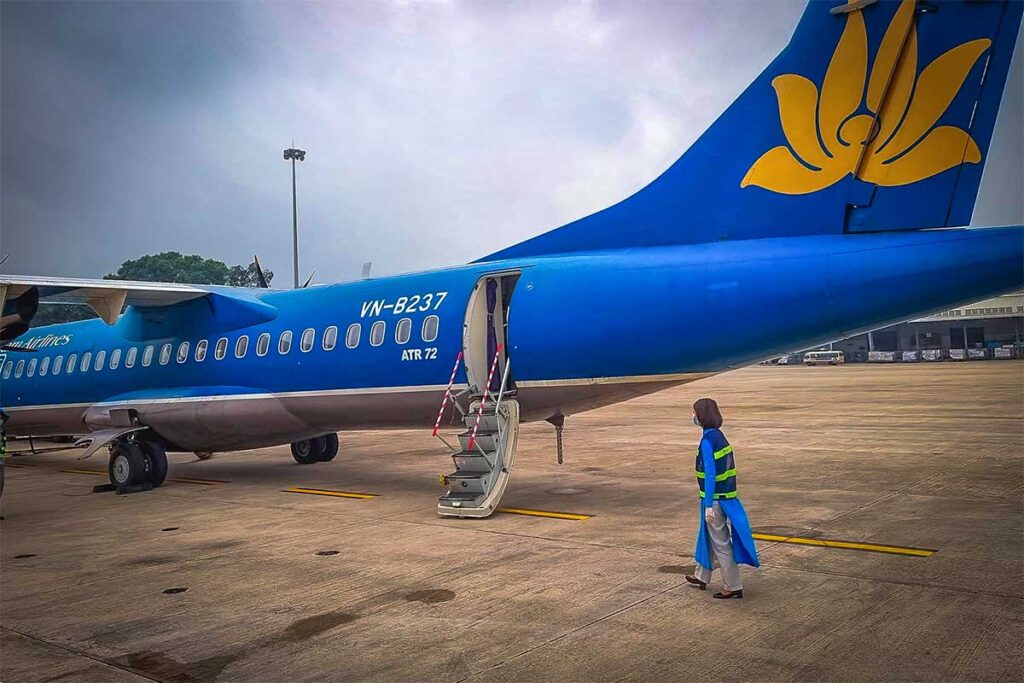A smaller Vietnam Airlines plane parked on the airport of Dien Bien Phu