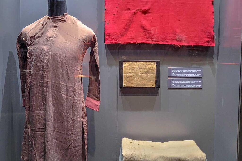 Personal items like clothes and a letter displayed at Vietnam Military History Museum in Hanoi