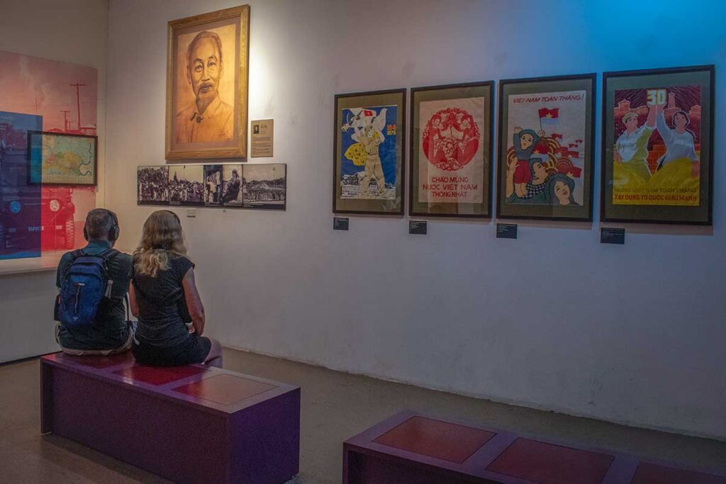 Visitors to the Vietnamese Women's Museum with posters, photographs and artifacts describing the role of Vietnamese women in the war, the country's history and contemporary society