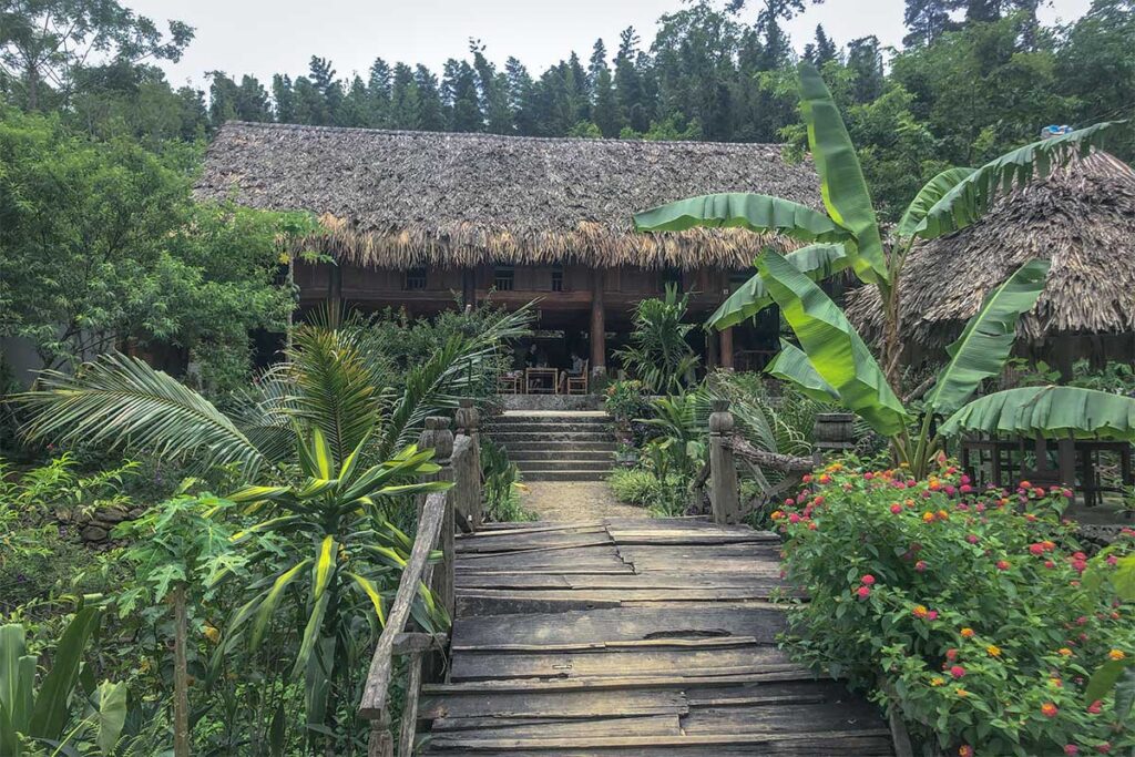 A small wooden bridge leading to a stilt homestay inside Xuan Son National Park