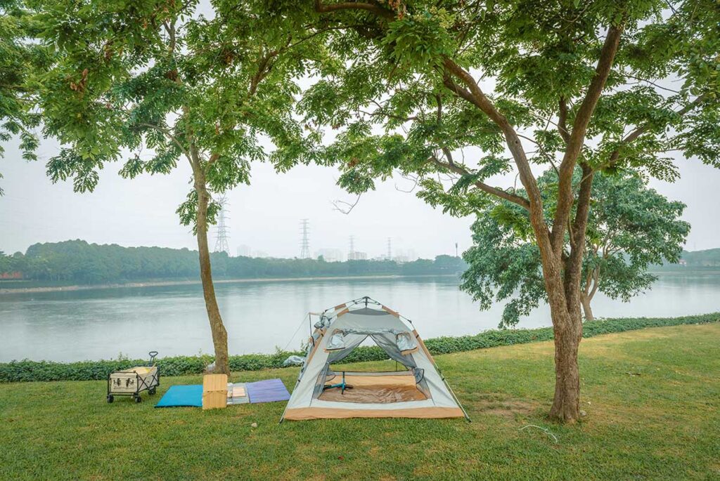 A tent set up next to a lake inside Yen So Park - Hanoi