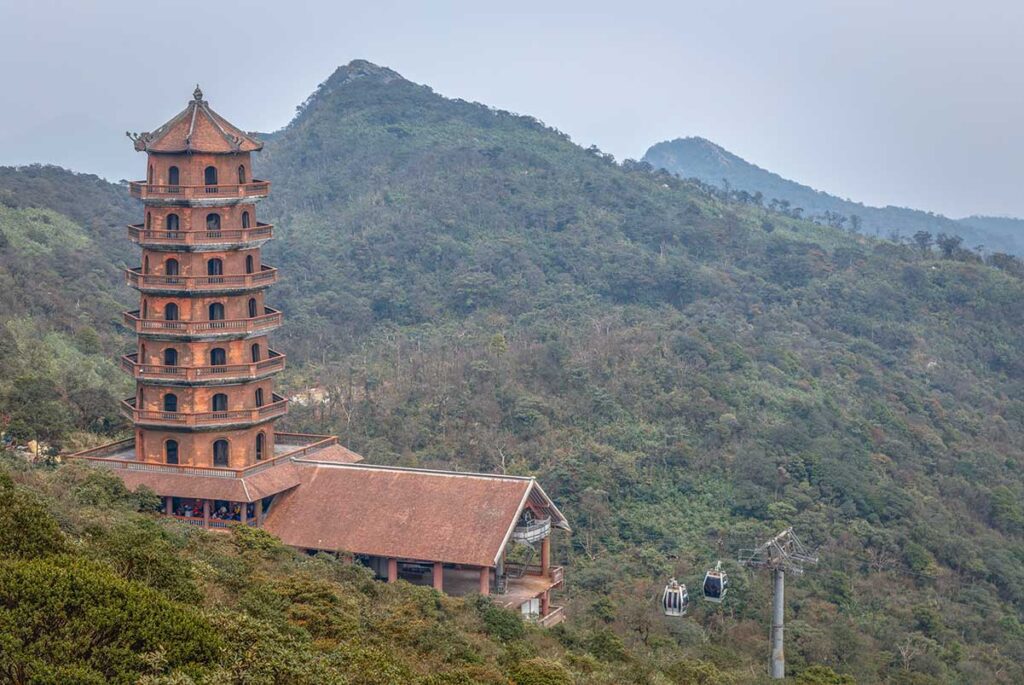 A stupa on Yen Tu Mountain with cable car in the background