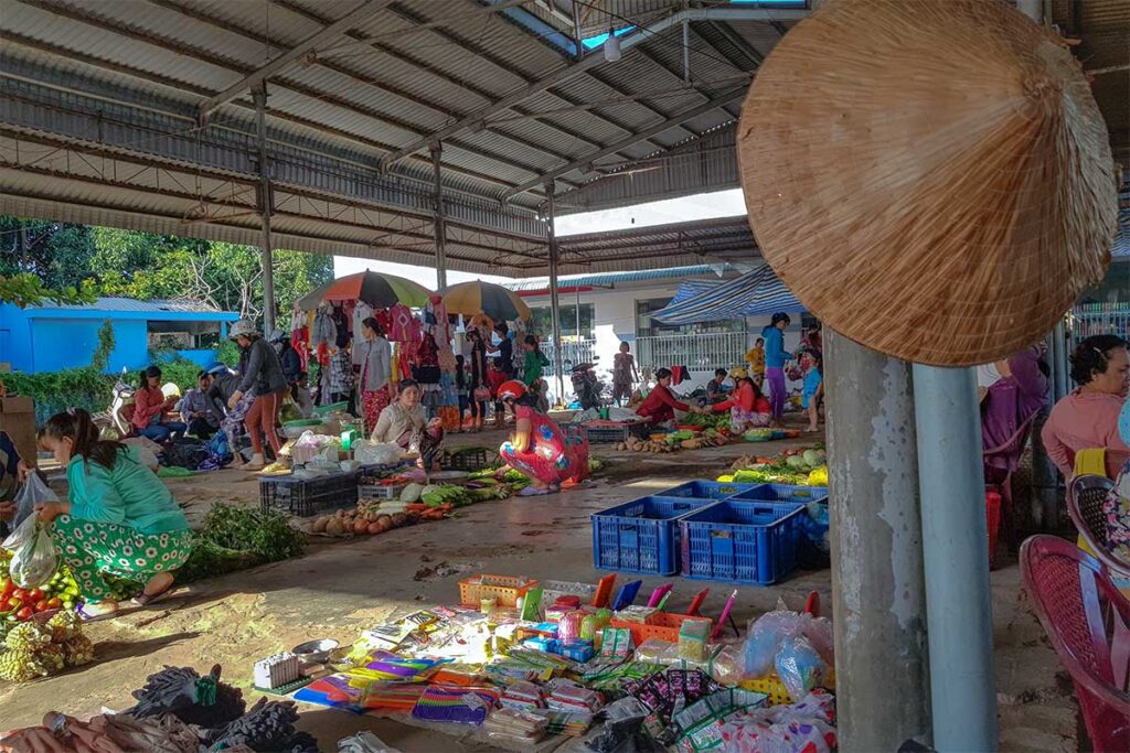 The simple and local An Binh Market without stalls but mats on the floor and vendors squatting 