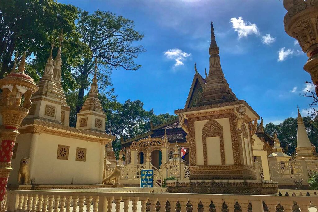Ornate stupas and shrines in the courtyard of Ang Pagoda in Tra Vinh with Khmer architectural details.
