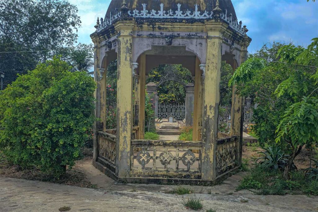 Weathered pavilion and family cemetery inside the garden of Ba Duc Ancient House