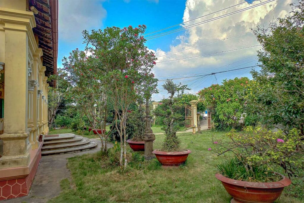 Garden view beside the colonial façade of Ba Duc Ancient House in Cai Be