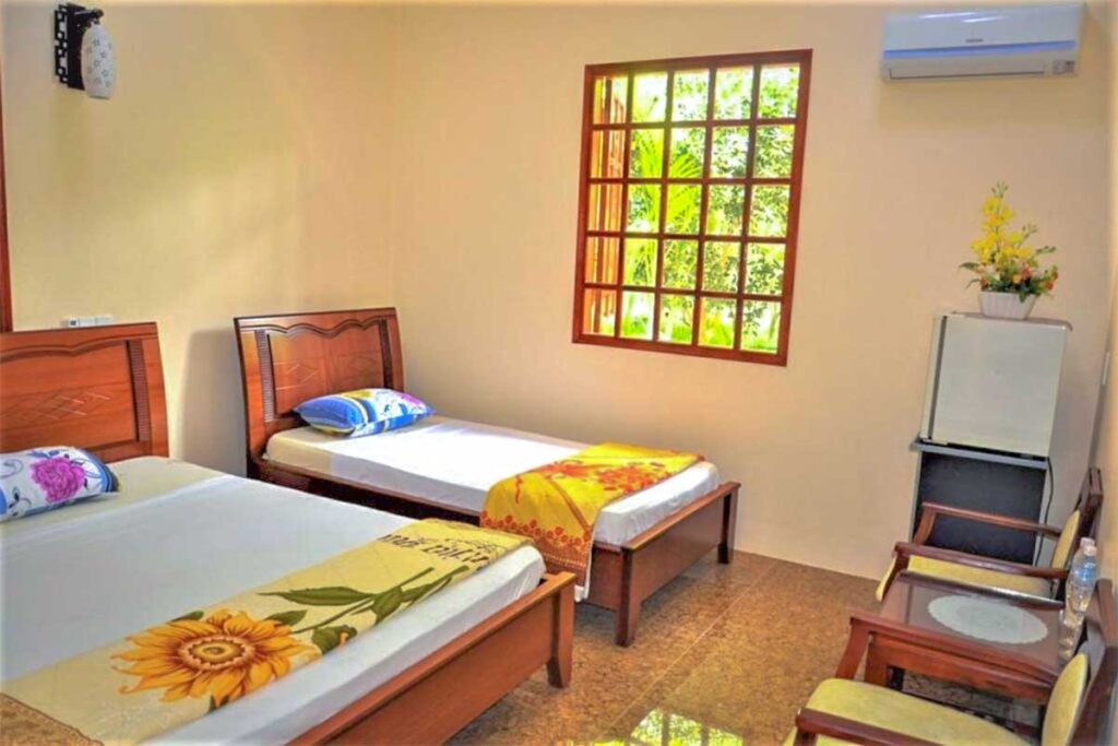Simple guest room in the newer building at Ba Duc Ancient House homestay, Cai Be