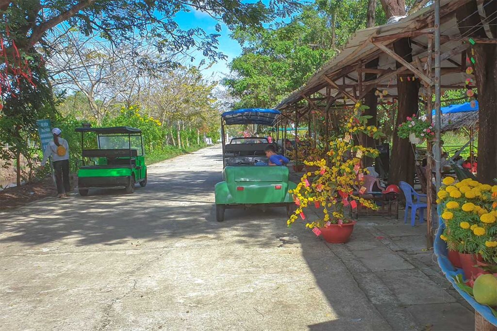 Two electric carts waiting at the entrance of Bac Lieu Bird Sanctuary