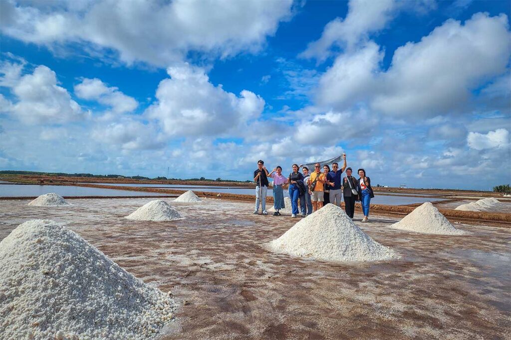 People are taking photos at salt piles at Bac Lieu Salt Fields