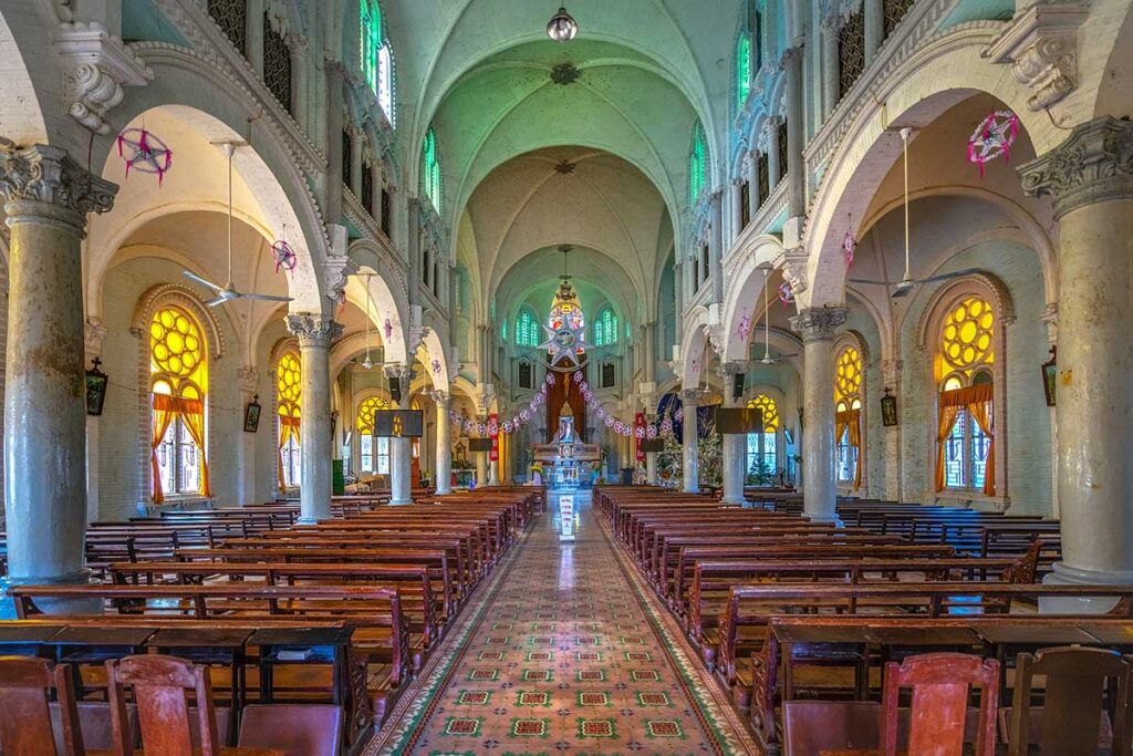Rows of benches and altar on the end inside Cai Be Church