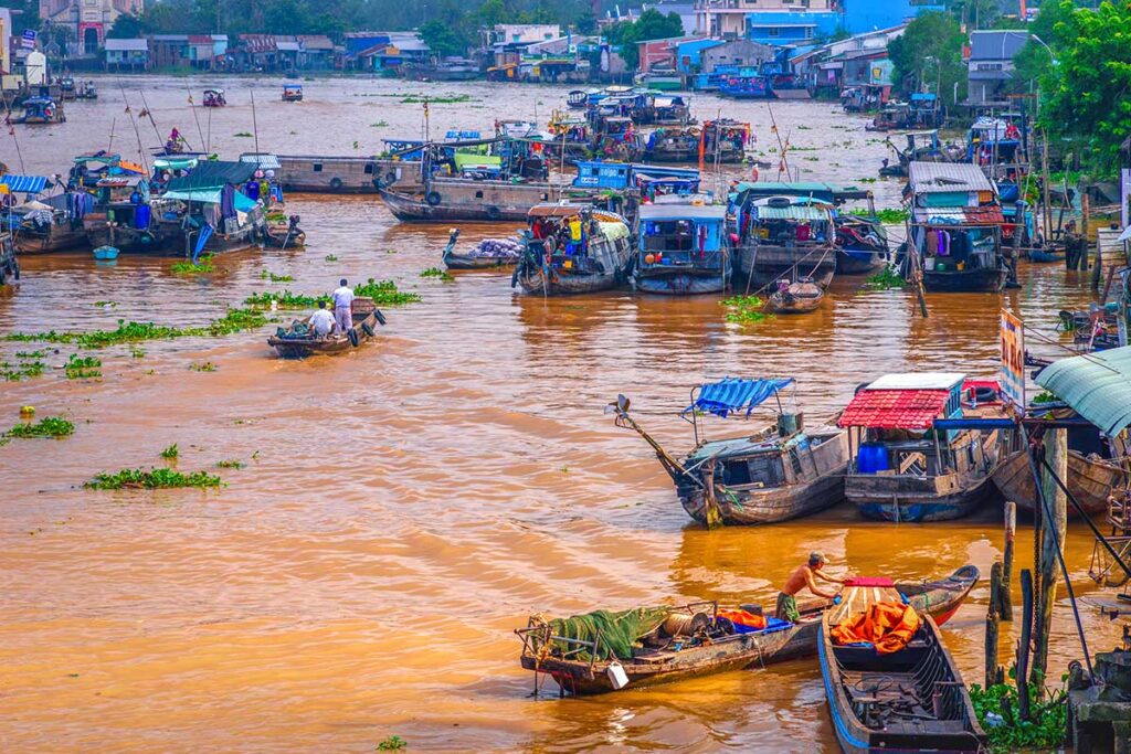 Overhead view of Cai Be Floating Market with small sampans and larger wholesale boats on the Mekong River