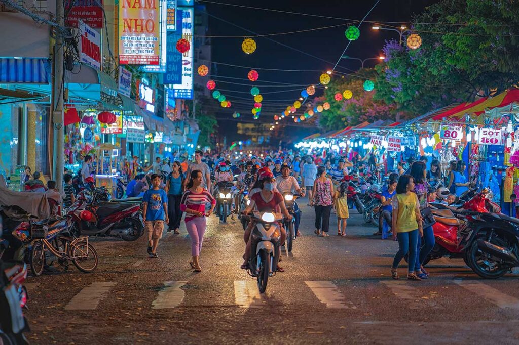 Locals and tourists walking along the stalls in the evening of Can Tho Night Market at Ninh Kieu Wharf