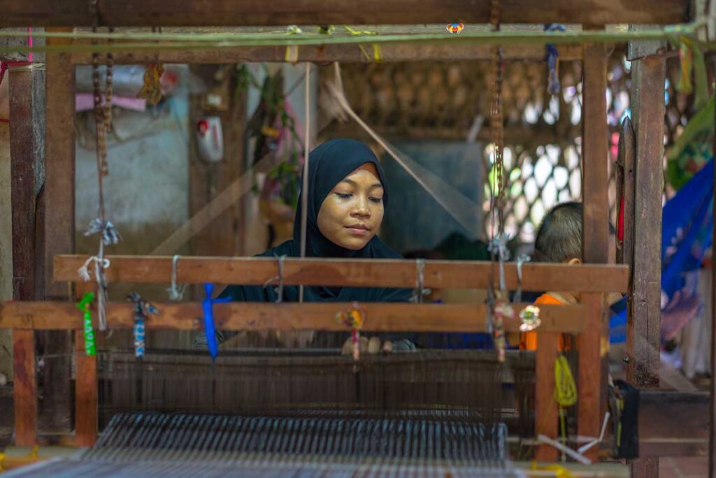 A muslim ethnic woman is weaving inside her house at Chau Giang Cham Village