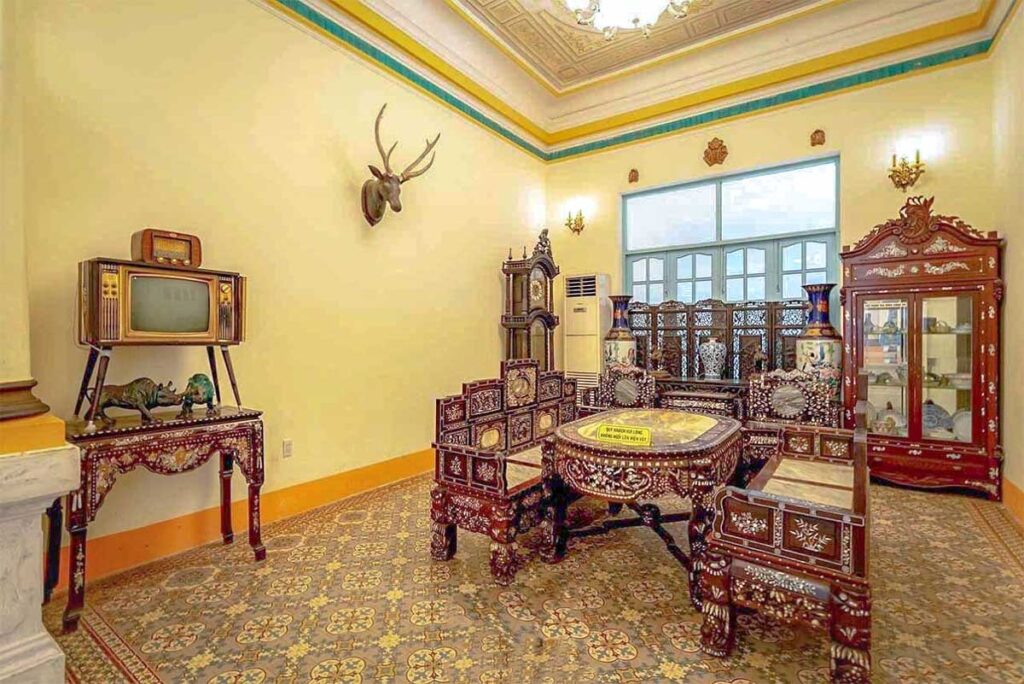 A living area with antique furniture  and old television inside Prince of Bac Lieu’s House