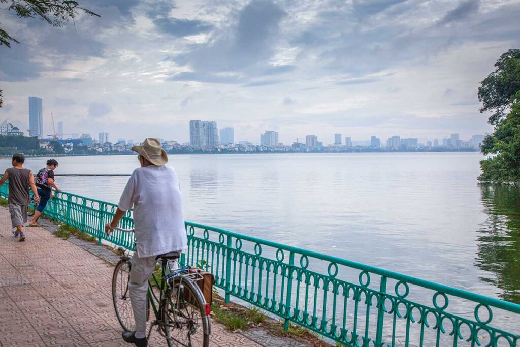 A man cycling around Truc Bach Lake in Hanoi