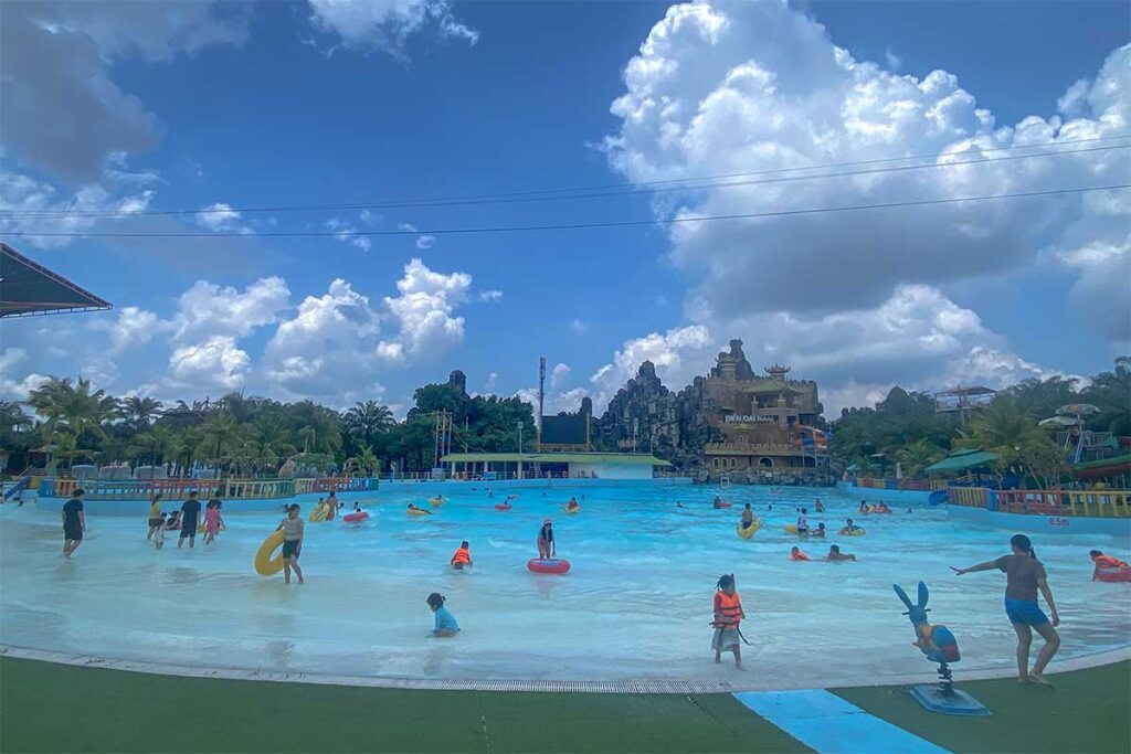 Kids and parents are playing in a large pool part of Dai Nam Beach (an artificial beach)