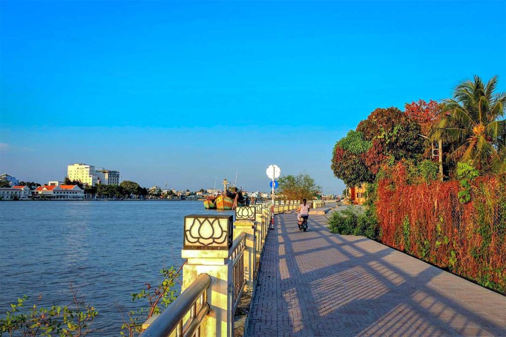 cenic riverside at Dragon Island (Tân Long), with moored boats and river traffic near My Tho.