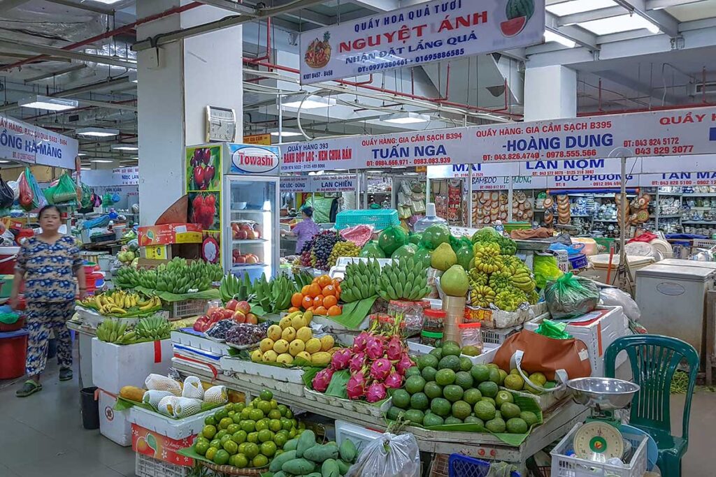 Lots of fruits and vegetables at different stalls in Hang Da Market in Hanoi