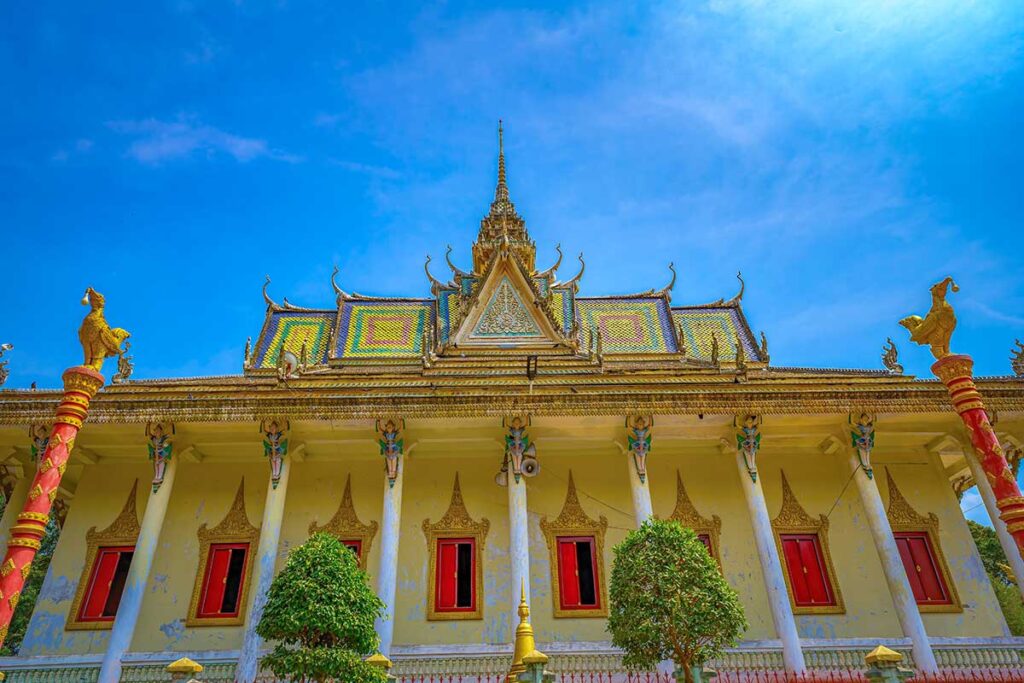 Close-up of the main hall at Hang Pagoda, highlighting the ornate roof design and golden bird statues.