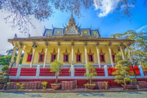 Front view of Hang Pagoda (Cave Pagoda) showing Khmer Buddhist architecture with red doors and decorative roof.