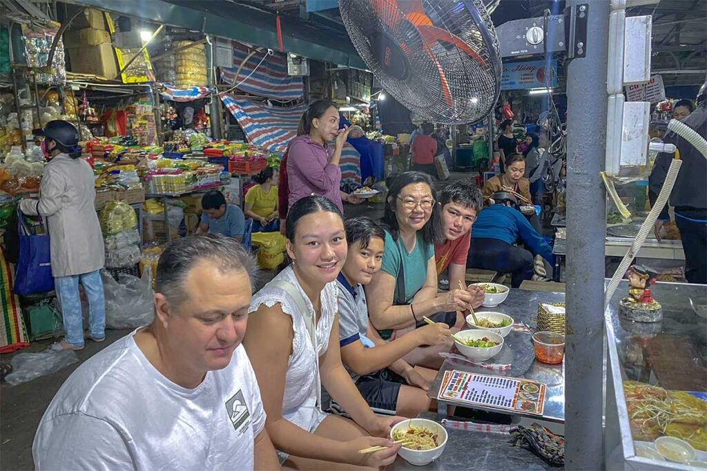 Tourists are doing a Hue street food tour - eating a local restaurant