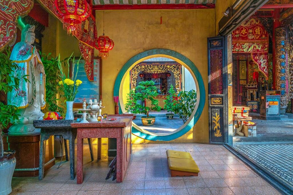 Side altar and circular moon gate inside Kien An Cung Temple, Sa Dec