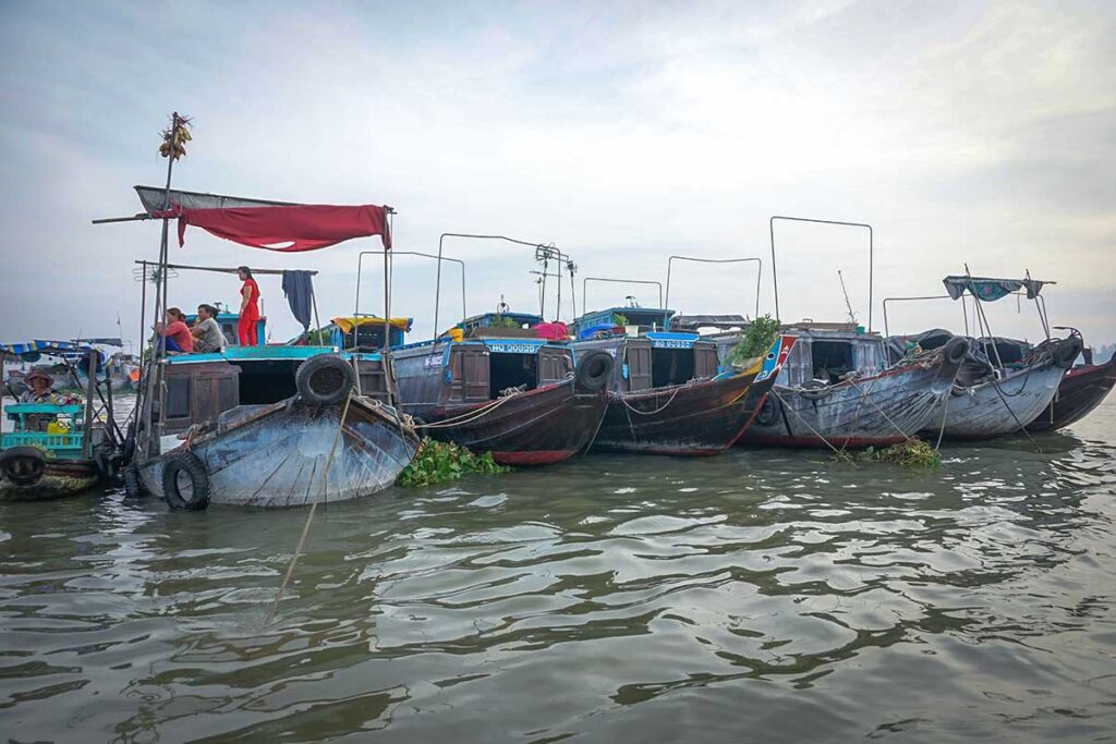 Row of traditional trading boats at Long Xuyen Floating Market on the Hau River