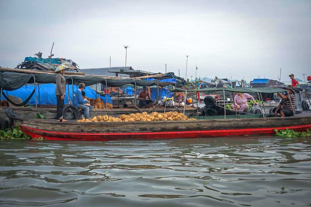 Boat at Long Xuyen Floating Market selling coconuts on the Hau River in An Giang, Vietnam