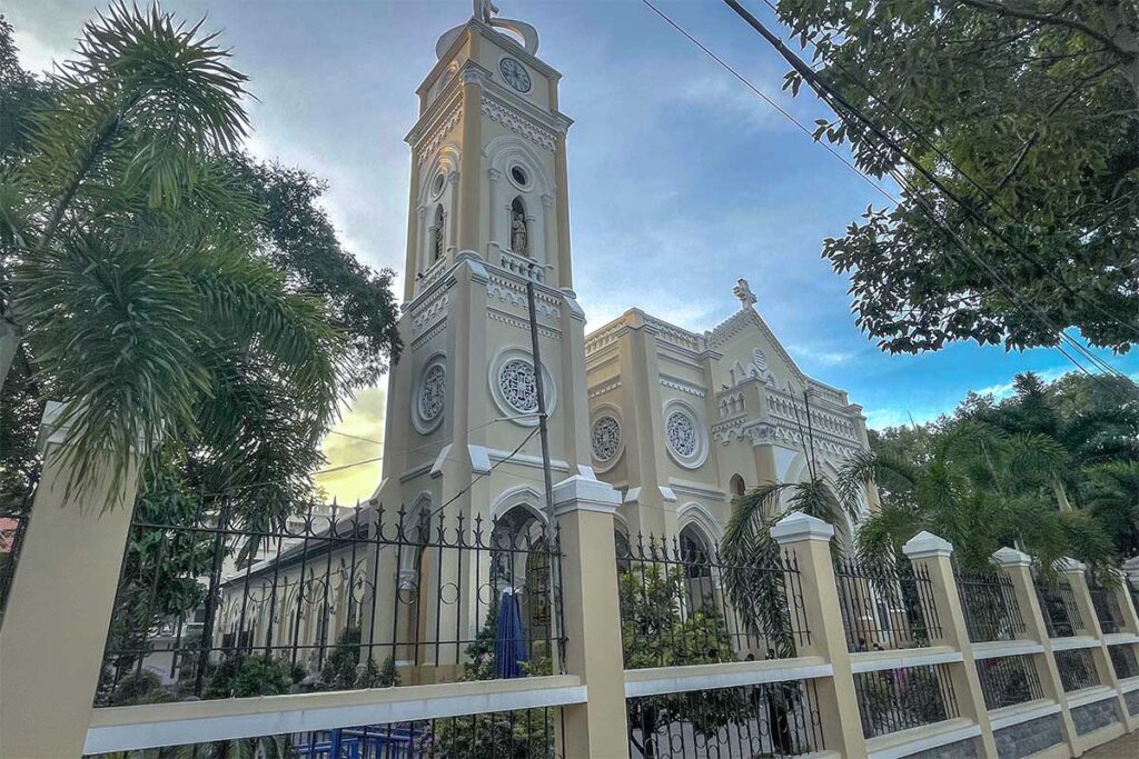 Exterior of My Tho Cathedral with bell tower at sunset, showing Greco-Roman Renaissance architecture in Tien Giang Province, Vietnam.
