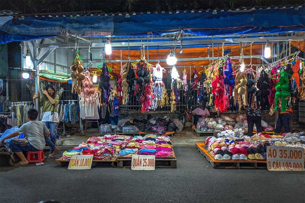 Street vendors selling clothes and accessories at My Tho Night Market, Tien Giang.