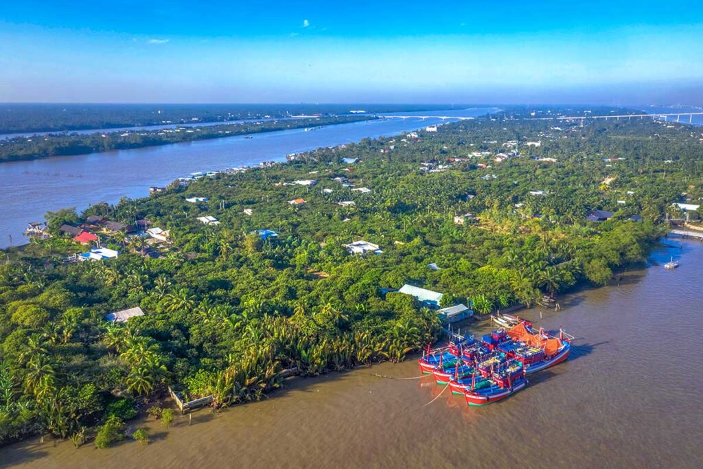 Scenic aerial photo of Phoenix Island (Phụng Islet) surrounded by lush greenery and the Tiền River, Ben Tre Province.
