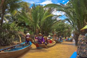 Rowboats paddling through nipa palm canals on Phoenix Island, a popular Mekong Delta activity.