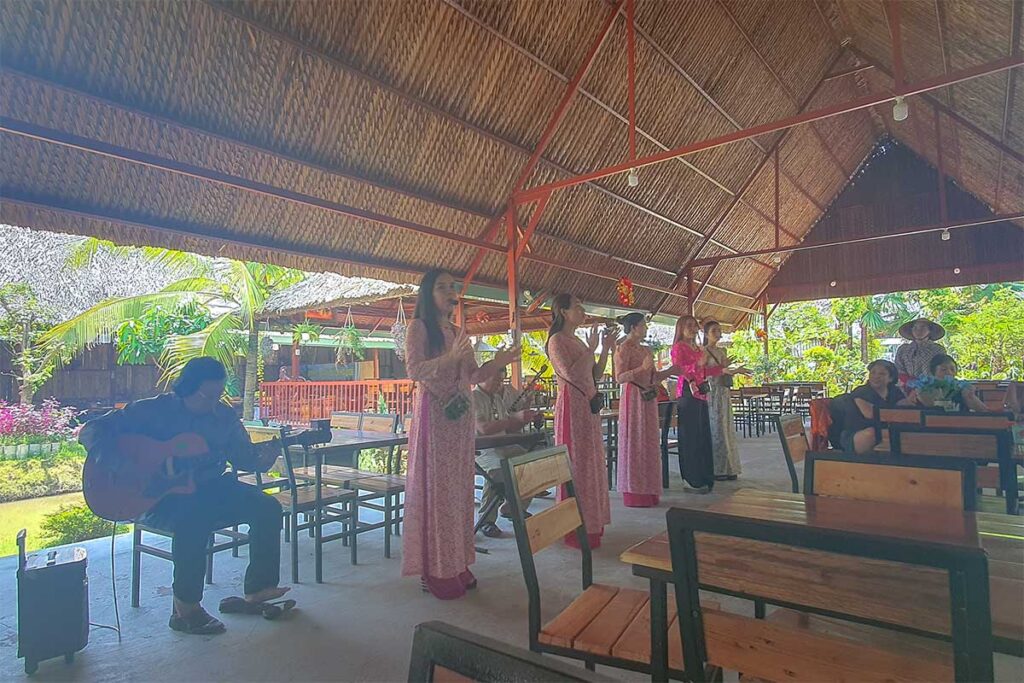 Southern folk music (Đờn Ca Tài Tử) performance with singers in traditional áo dài on Phoenix Island, Ben Tre.