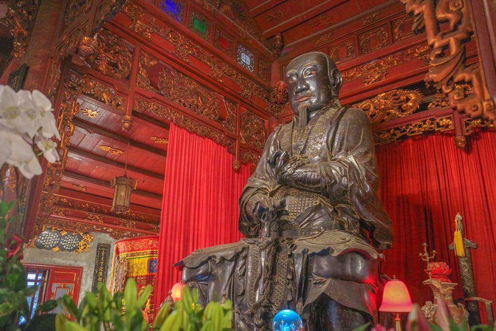 The main hall of Quan Thanh Temple with a large bronze statue of Tran Vu
