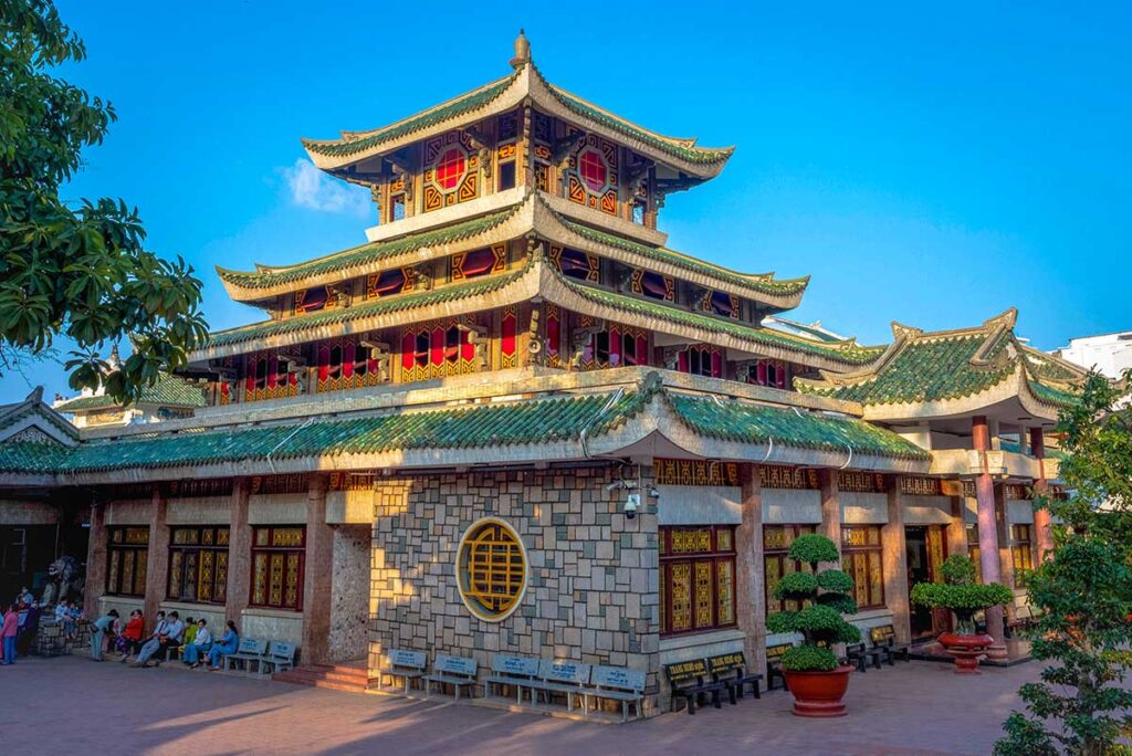 Ba Chua Xu Temple (Lady Temple) at the base of Sam Mountain in Chau Doc, with green tiled roofs and sacred atmosphere.