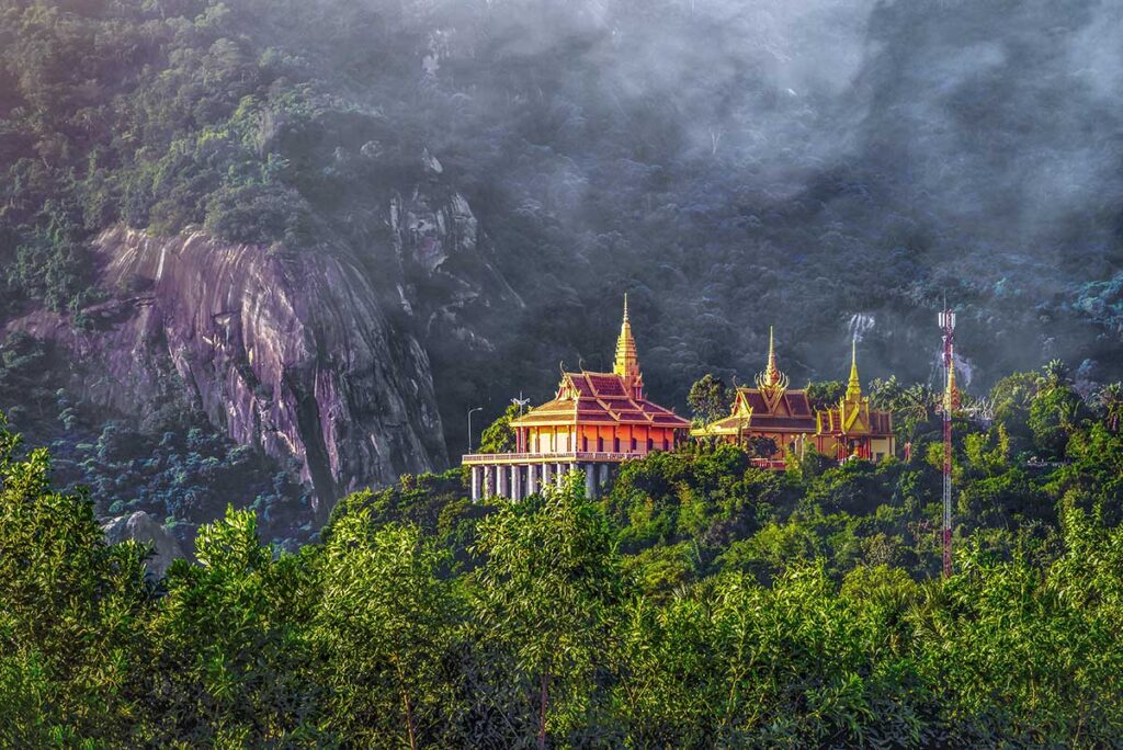 Ta Pa temple seen from the ground up high on the hill