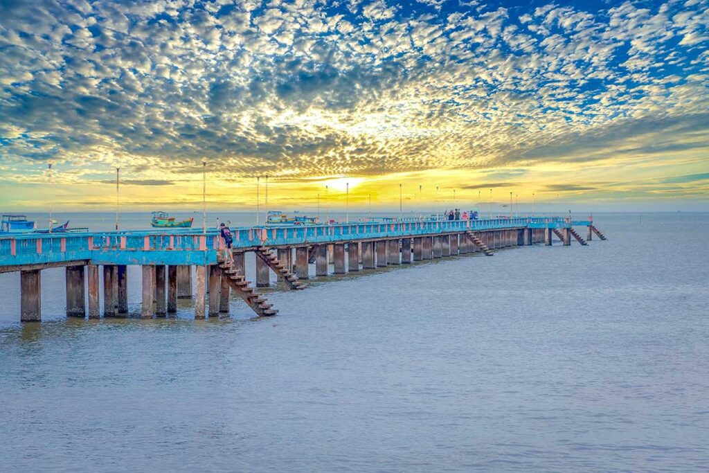 Concrete jetty stretching into the sea at Tan Thanh Beach Tien Giang, a popular spot for sunset views.
