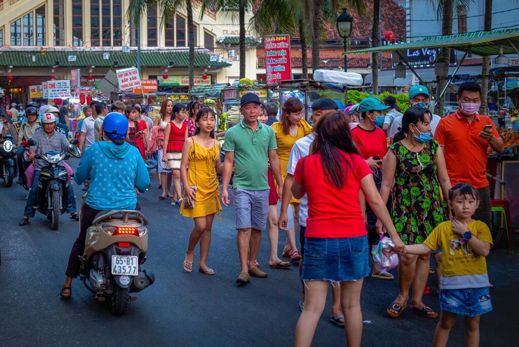 Locals walking along the stalls of Tay Do Night Market