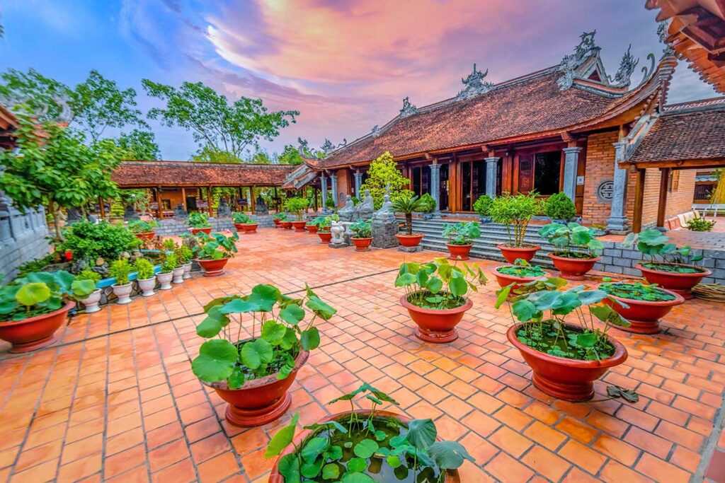 Lotus pots arranged in the courtyard of Truc Lam Phuong Nam Zen Monastery in Can Tho at sunset.